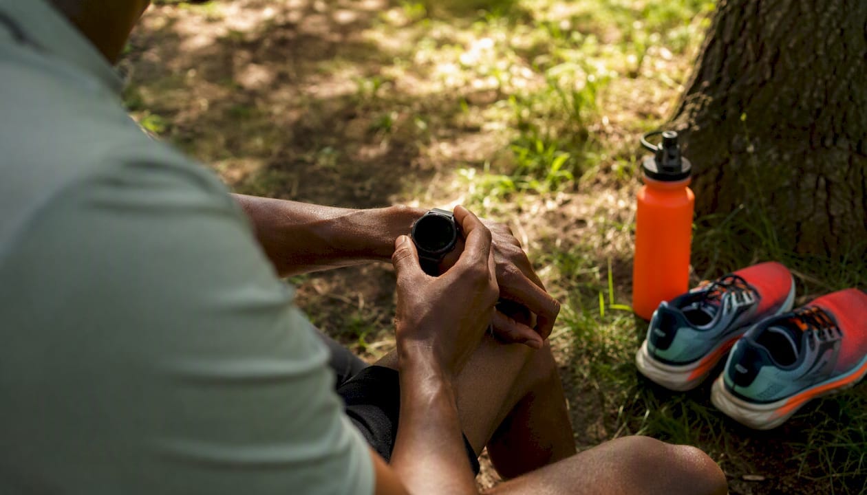 Runner checking fitness watch during training