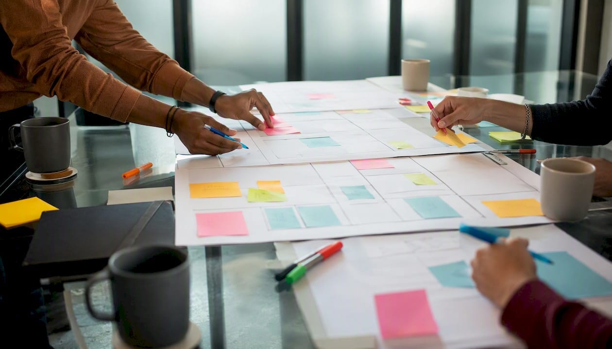 Hands working on business model canvases