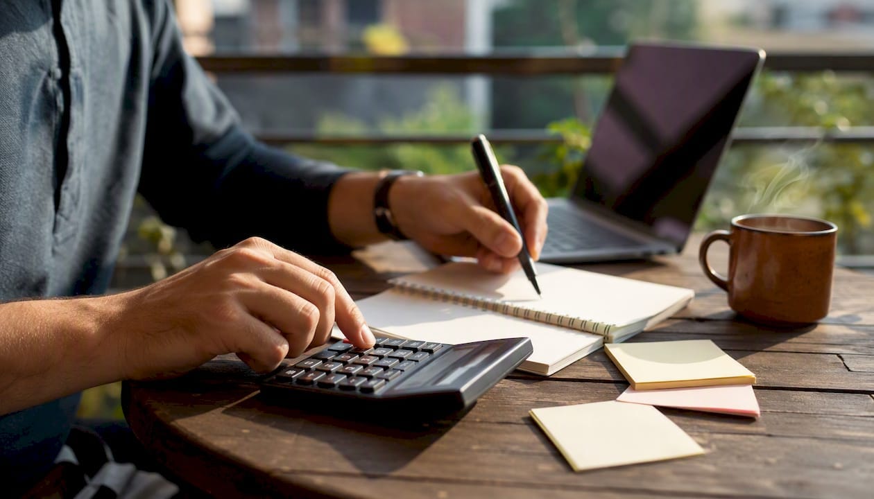 Hands calculating startup equity shares