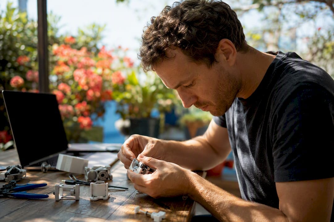 Hands adapting prototype in workshop
