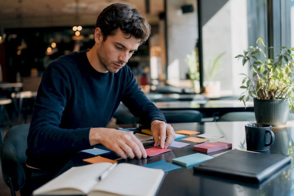Hands arranging growth strategy cards on table