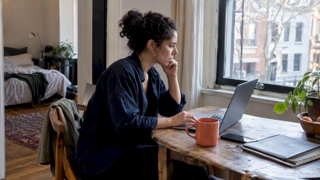 Remote professional working in a temporary apartment
